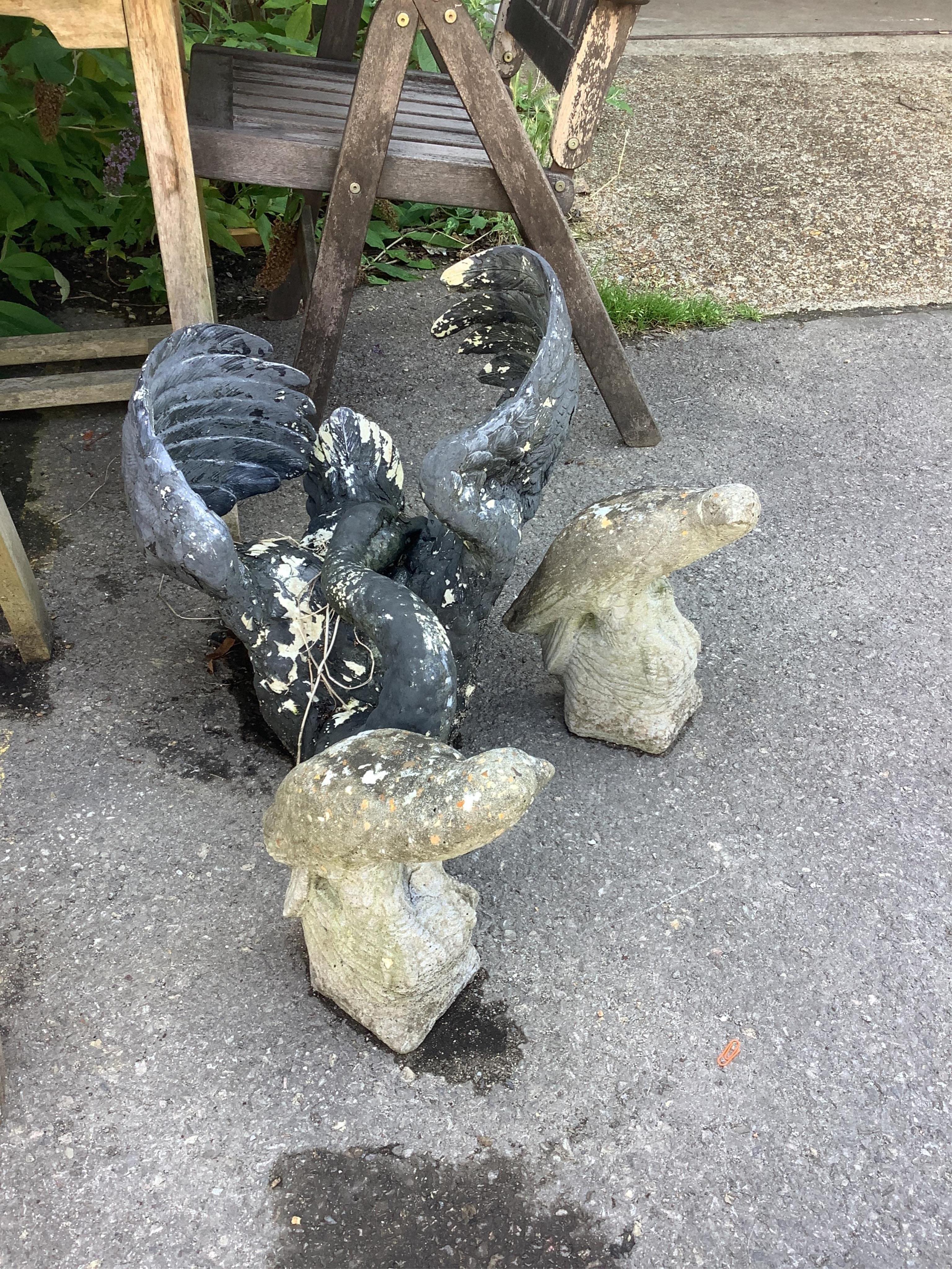 A painted resin swan garden ornament, length 54cm, together with a pair of reconstituted parrot garden ornaments. Condition - fair